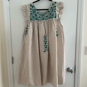 Tan and cream stripes with teal embroidery. Never worn.